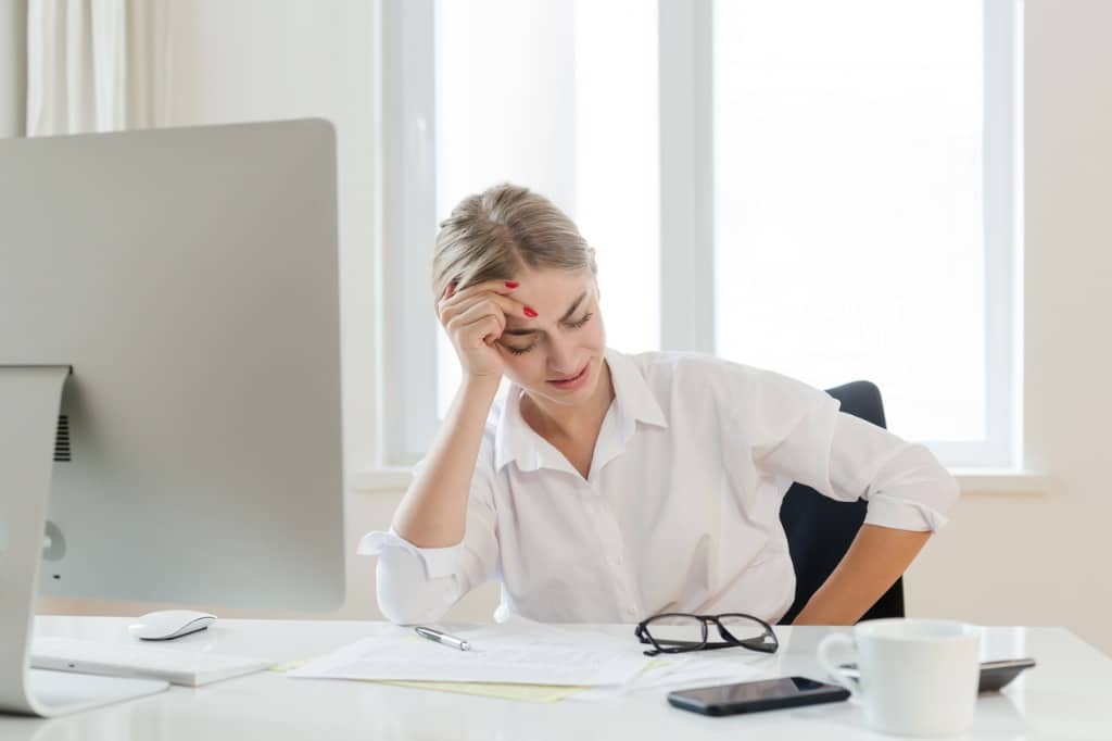 Business woman stressed out and experiencing stomach pain